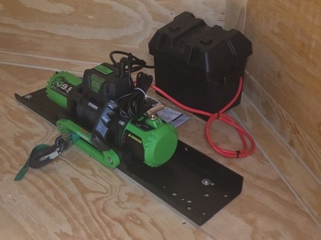 Built-in 9,000 lb winch and battery box at the front of the 24 ft enclosed trailer
