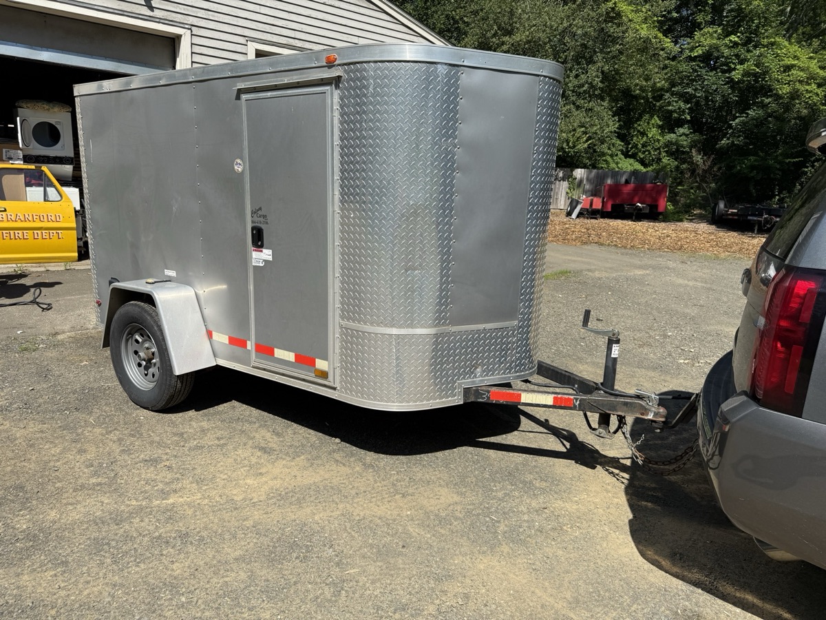 5×8 enclosed cargo trailer rental hitched to an SUV