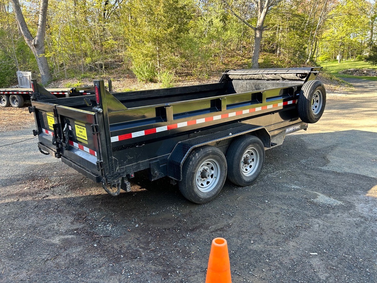 Tandem-axle dump trailer for rent in Branford, CT, rear three-quarter view