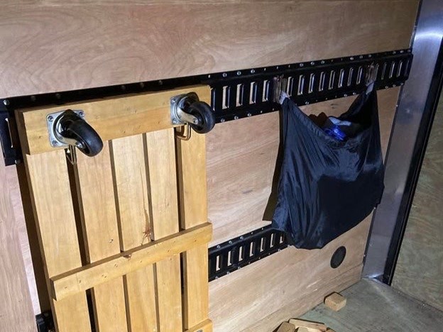 E-Track rails on the walls inside the enclosed cargo trailer rental