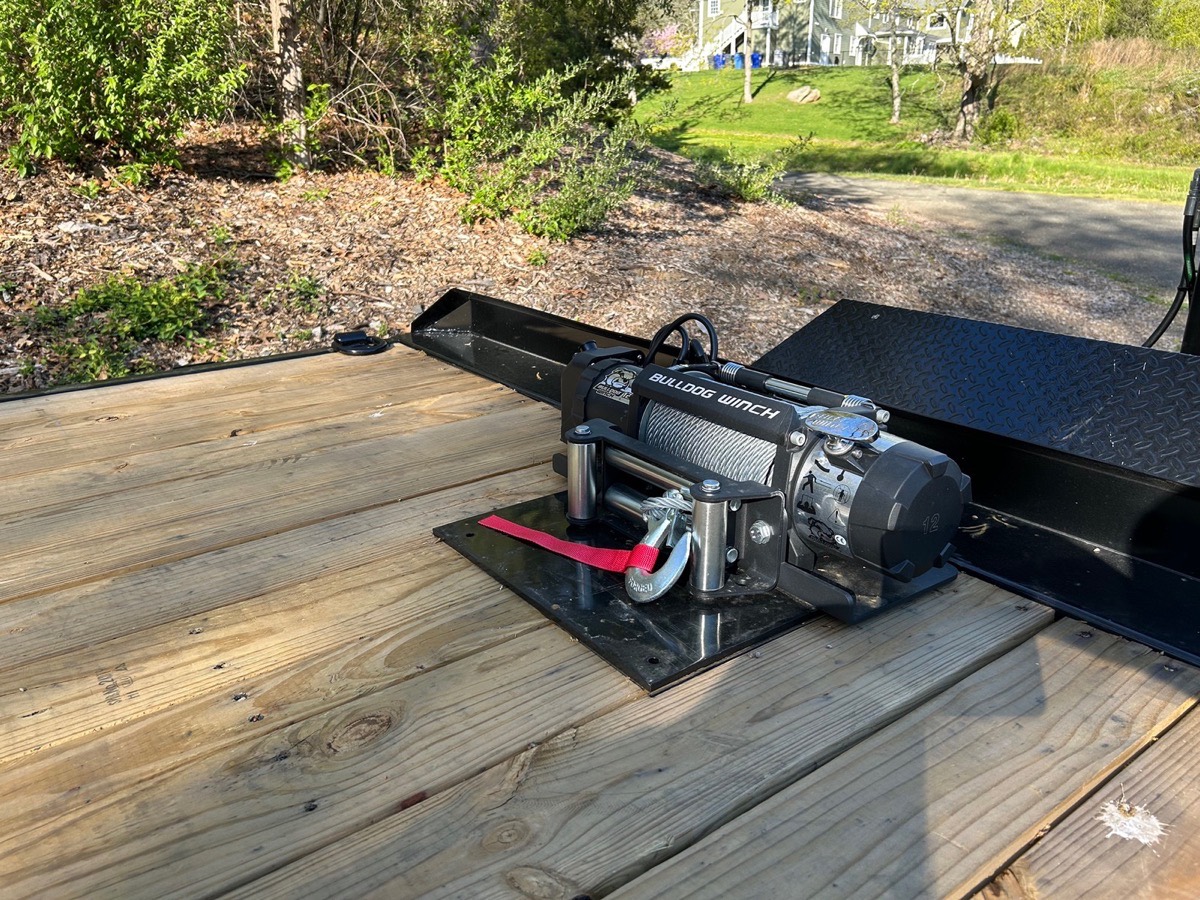12,000 lb winch mounted at the front of the deckover equipment trailer
